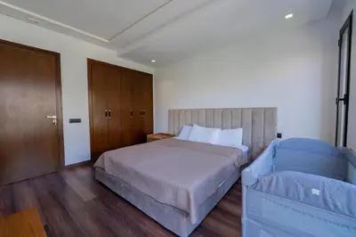 a bedroom with a bed and a wooden door at Jack Beach Bay in Tamaris
