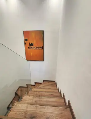 a picture of a painting on a wall next to stairs at The 28 Triangle d'Or by IB Signature - Stylish two-Bedroom flat - Wifi, Self Check-in, Day and Night Security, Terrace, Swimming pool, free parking close to all amenities in Casablanca
