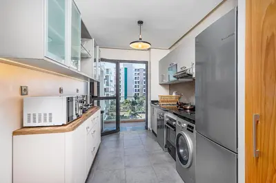 a kitchen with a washer and dryer at Luxury Apartment Perles d'Agdal, Facing Agdal Station in Rabat