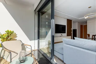 a living room with a couch and a chair at Luxury Apartment Perles d'Agdal, Facing Agdal Station in Rabat