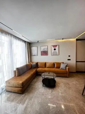 a living room with a brown couch and a table at New luxury central apartment in Casablanca