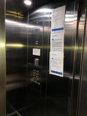 a metal elevator with a sign on it at Apartment with large terrace Mohammedia in Mohammedia