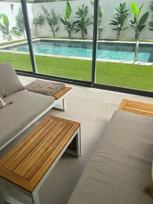 a living room with a couch and a swimming pool at Apartement avec piscine privée Casablanca in Casablanca