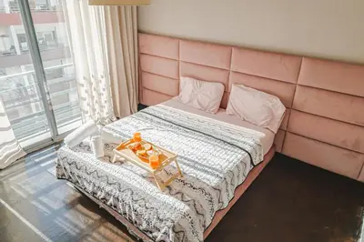 a bedroom with a bed with a pink headboard at VIVASTAY Casablanca - Urban Nest 3 Bedrooms High Standing Les Princesses in Casablanca