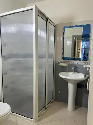 a bathroom with a shower and a sink at Appartement calme et lumineux à Harhoura in El Harhoura