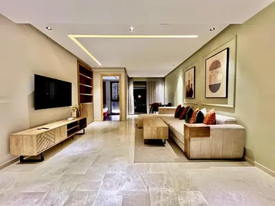 a large living room with a couch and a tv at Logement cosy avec terrasse in Casablanca