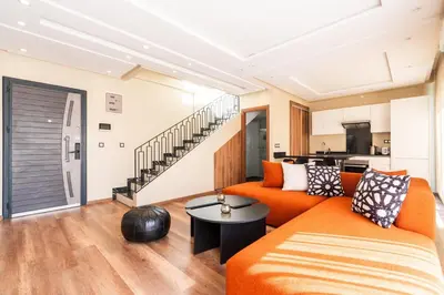 a living room with an orange couch and a table at Résidence Dunkerque - Duplex in Casablanca