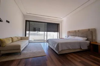 a bedroom with a bed and a couch and a window at Villa vue océan Jack Beach Bay in Tamaris