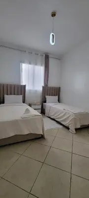 two beds sitting in a room with at Appartement casablanca in Casablanca