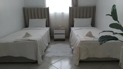 two beds sitting next to each other in a room at Appartement casablanca in Casablanca