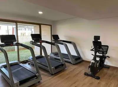 a gym with three treadmills and elliptical machines at Blue Carrousel in Rabat