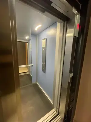 an elevator corridor in a building with a mirror at Apartment in Manesman beach in Mohammedia