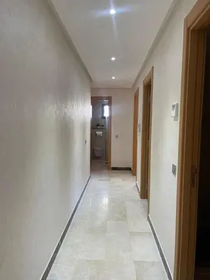 an empty hallway with a hallway leading to a bathroom at Apartment in Manesman beach in Mohammedia