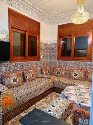 a living room with a couch and windows at Beautiful apartment with all comforts in Rabat