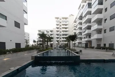 a swimming pool in the courtyard of a apartment building at Beautiful apartment with pool view in Aïn Harrouda