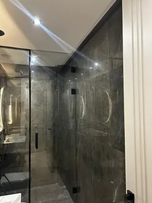 a bathroom with a shower with a glass door at Prestige Aman in Casablanca