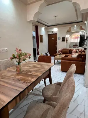 a living room with a wooden table and chairs at Super apartment Near Hassan II Mosk and Corniche in Casablanca