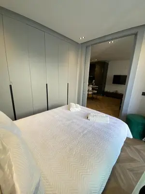 a large white bed in a room with a large mirror at Cosy & Modern apartment with balcony, fiber WiFi & air conditioning Close To KFC & Mcdo Bd 2 Mars In The Heart Of Casablanca in Casablanca