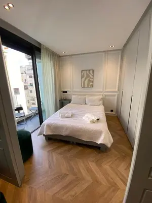 a bedroom with a large bed and a large window at Cosy & Modern apartment with balcony, fiber WiFi & air conditioning Close To KFC & Mcdo Bd 2 Mars In The Heart Of Casablanca in Casablanca