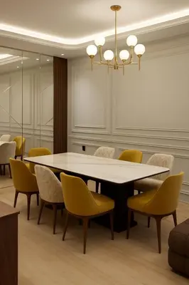 a dining room with a table and yellow chairs at Margueri Luxe in Mohammedia