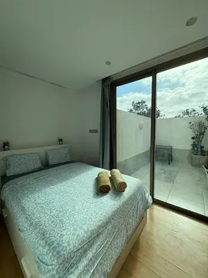 a bedroom with a bed with two shoes on it at Chic One Bedromm Apartment - Large Terrace - Anfa District in Casablanca