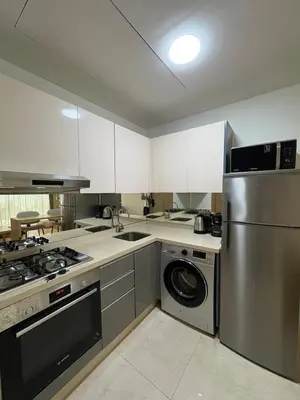 a kitchen with a stainless steel refrigerator and a dishwasher at Chic One Bedromm Apartment - Large Terrace - Anfa District in Casablanca