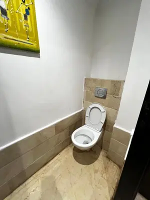 a bathroom with a white toilet in a stall at Maison Vacances in Casablanca