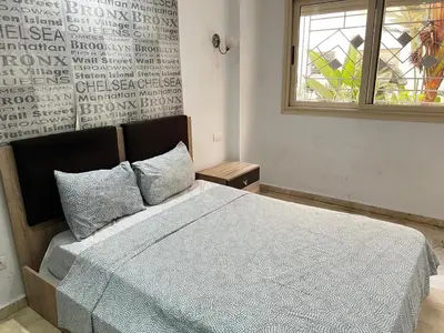 a bedroom with a bed and a window at Maison Vacances in Casablanca
