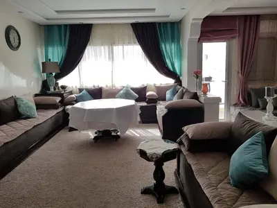 a living room with a couch and a table at Apartment at Melissa's, sea view, Res Assabah in Rabat