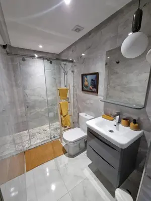 a bathroom with a toilet and a sink and a shower at downtown rabat luxury in Rabat