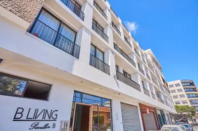 a white building with a black sign on it at Le loft du soleil B living in Casablanca