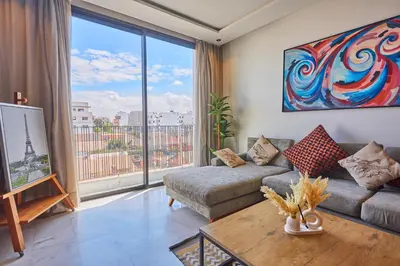 a living room with a couch and a large window at Le loft du soleil B living in Casablanca