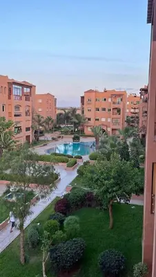 a view of a courtyard with a pool in a city at appartement a louer el mansouria in Pont Blondin