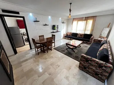 a living room with a couch and a table at Complexe Horizon in Casablanca