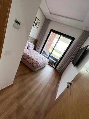 a small bedroom with a bed and a window at Olivia Farm in Aïn el Apuda