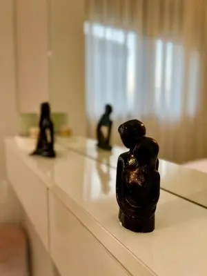 a black sculpture of two people sitting on a counter at Studio Neuf à Roches Noires près de Casa Voyageurs et Casa Port in Casablanca