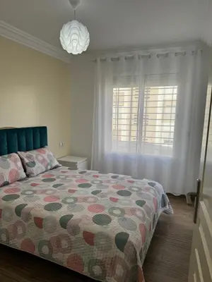 a bedroom with a bed and two windows at Blue Ocean Escape Sidi Rhal in Sidi Rahal