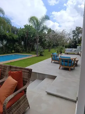 a patio with chairs and a table and a pool at Hamza in Temara