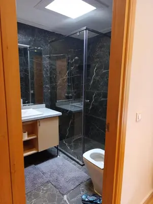 a bathroom with a shower and a sink and a toilet at Hamza in Temara