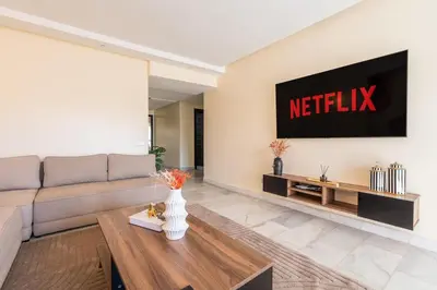 a living room with a couch and a tv at Yacht appartement Waterfront Complex 2 Bedrooms 2 Bathrooms in Casablanca