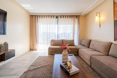 a living room with a couch and a table at Yacht appartement Waterfront Complex 2 Bedrooms 2 Bathrooms in Casablanca