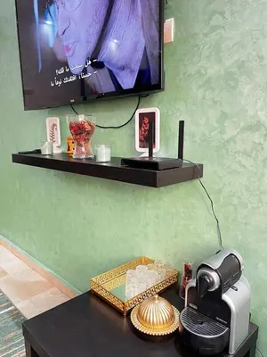 a room with a tv and a table with a printer at Morocco House in Casablanca