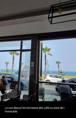 a room with a view of a parking lot with palm trees at majorelle luxury in Rabat