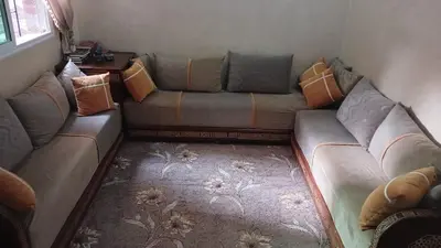a living room with a couch with pillows on it at Appartement Jad in Deroua