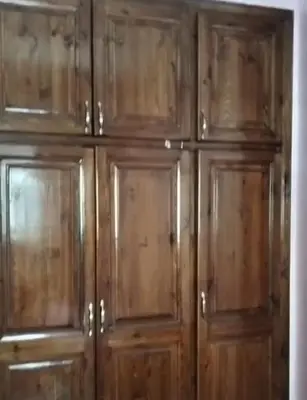 a bunch of wooden cabinets in a room at Appartement Jad in Deroua