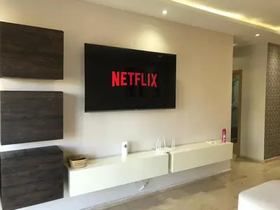 a television on a wall with a netflix sign on it at CAN25 2ch au centre de mohammedia in Mohammedia