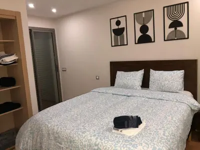 a bedroom with a bed with a purse on it at CAN25 2ch au centre de mohammedia in Mohammedia