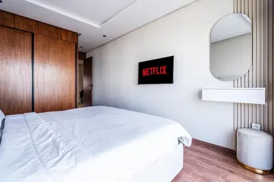 a bedroom with a white bed and a mirror at C06 Apartment - Luxury, Style & Wellness in Casablanca