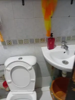 a bathroom with a white toilet and a sink at Belle chambre pour 2 sidi maarouf in Casablanca