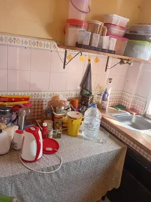 a kitchen counter with a counter top with dishes and a sink at Belle chambre pour 2 sidi maarouf in Casablanca